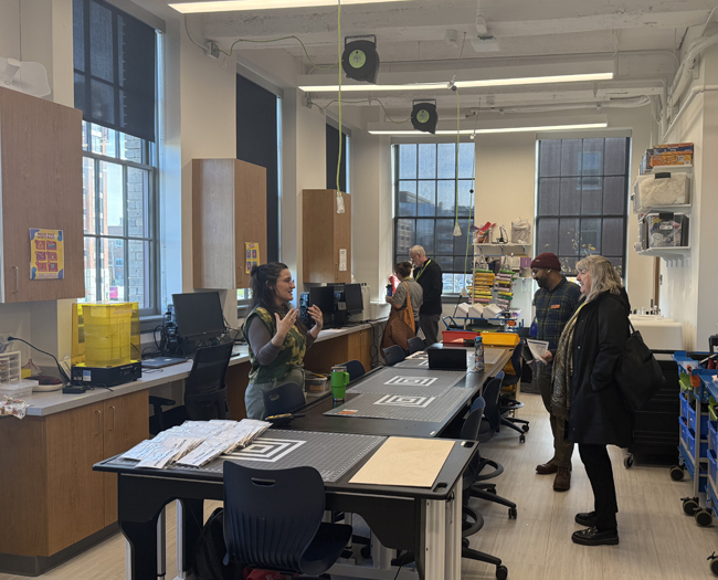 CUMU attendees explore the Steve and Mim Dubin Makerspace during a site visit to UMB’s Community Engagement Center.